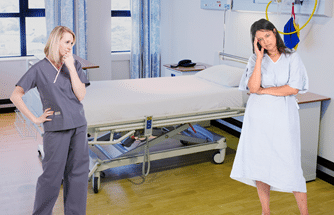 Two people in a hospital room - nurse and patient